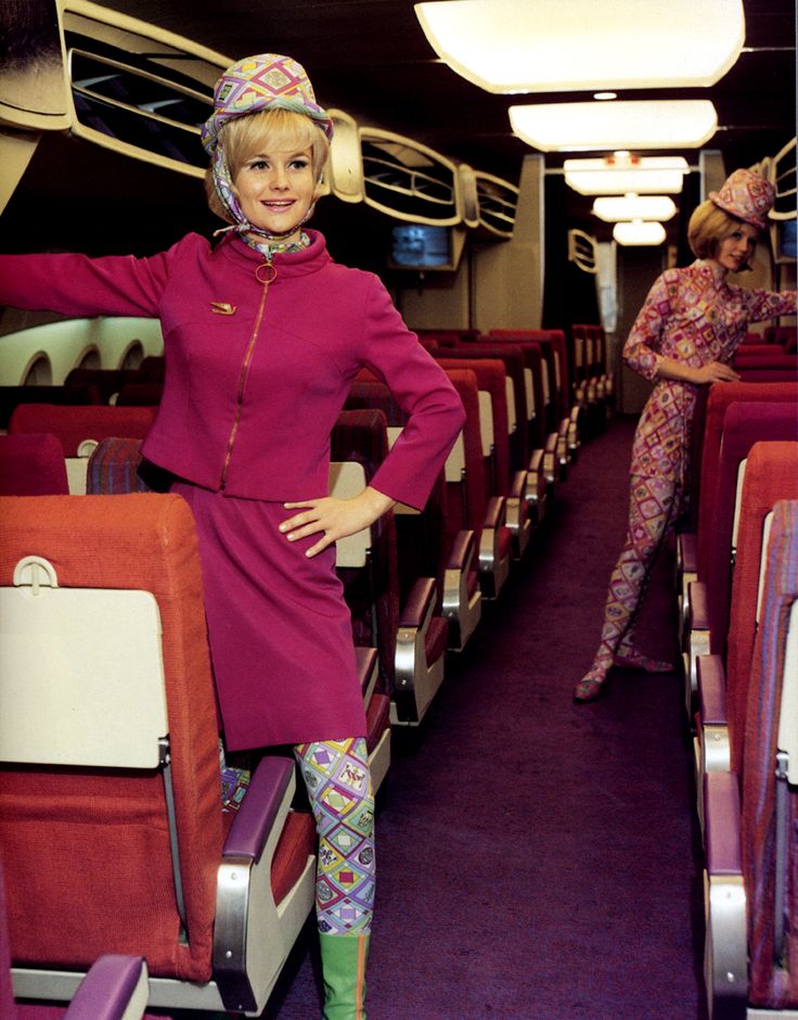A Braniff airliner interior with flight attendents in their new uniforms, 1965.