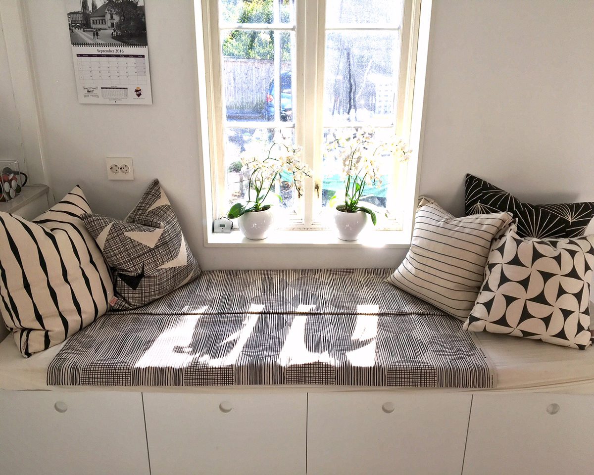 photo showing sunny window nook featuring Skinny laMinx fabrics, throw pillows and scatter cushions in black and white colours