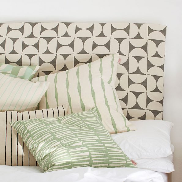 Skinny laMinx Headboard and throw pillows on bed